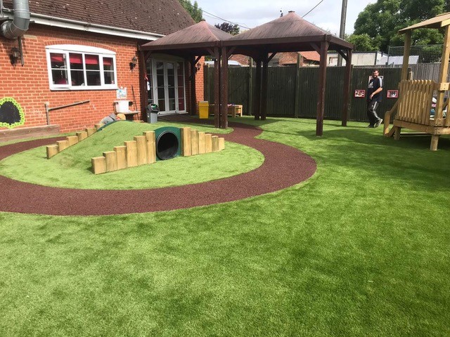 Artificial Grass mound and tunnel with rubber mulch pathway