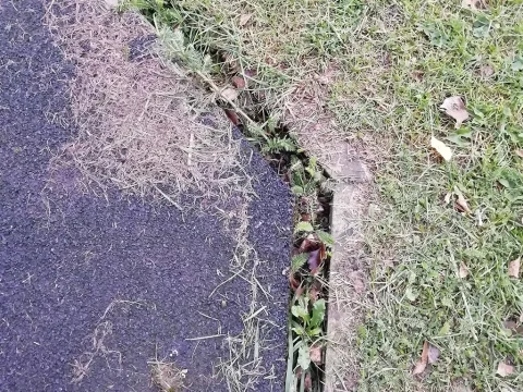 Edge of wetpour rubber surfacing shrinking away from edge